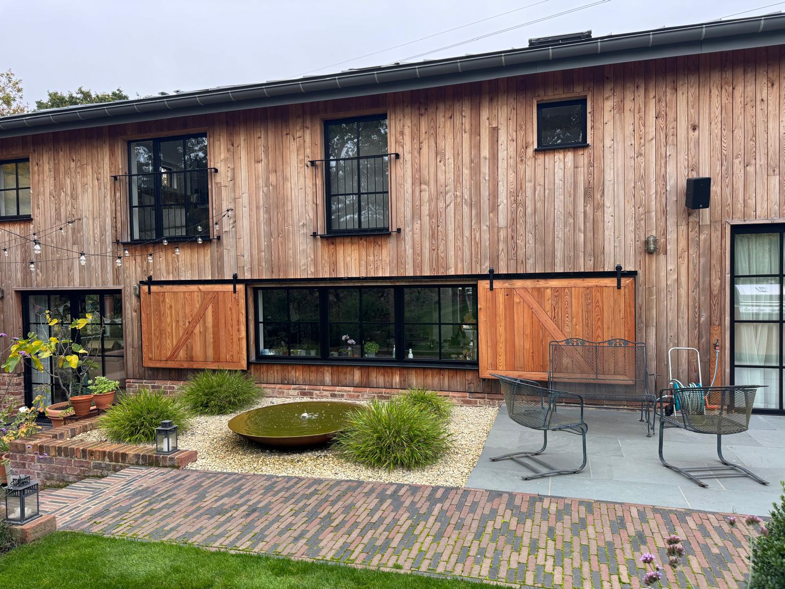Cedar clad house with barn doors